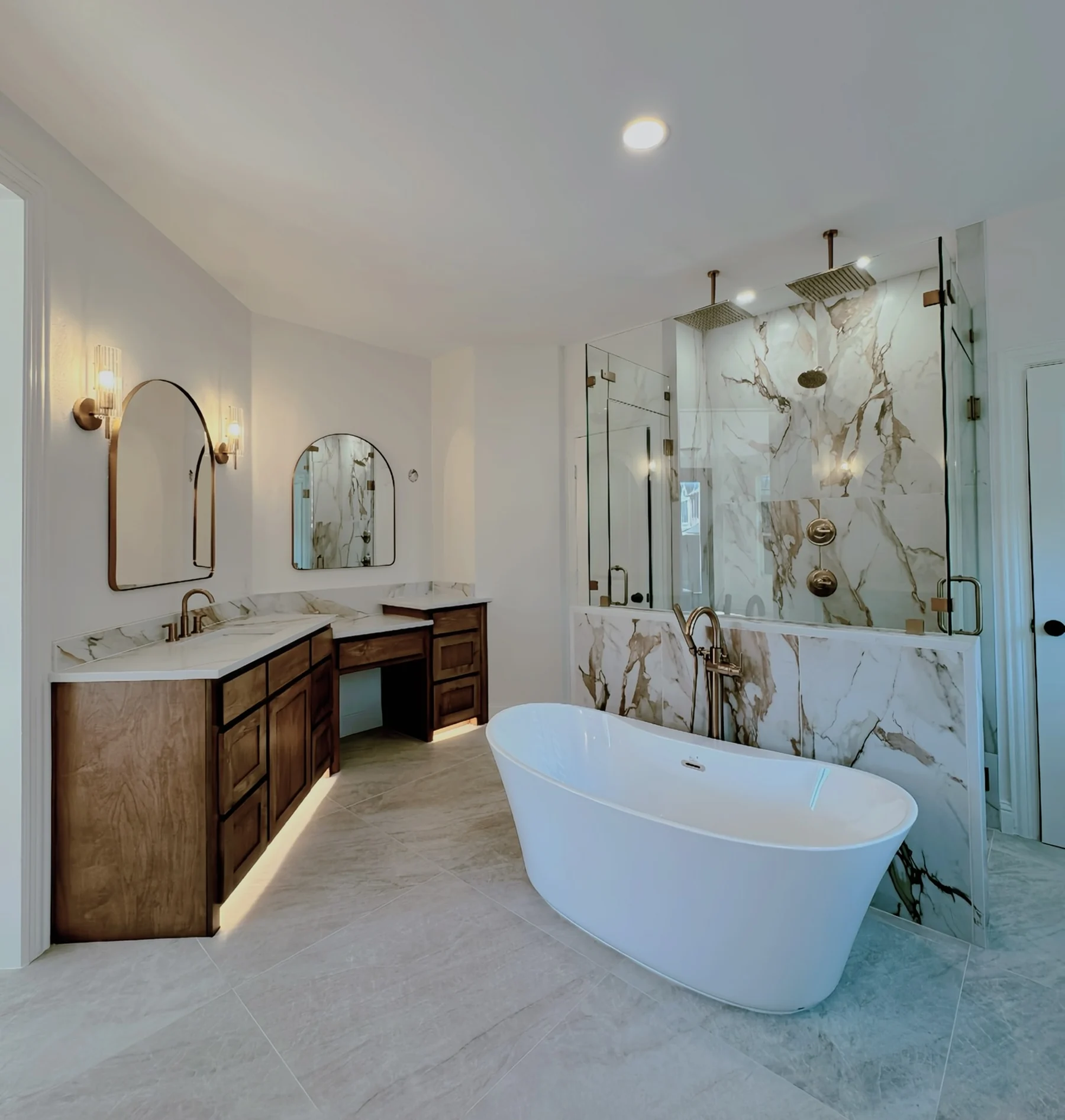 Modern Nomad primary bathroom remodel with freestanding tub and custom glass shower